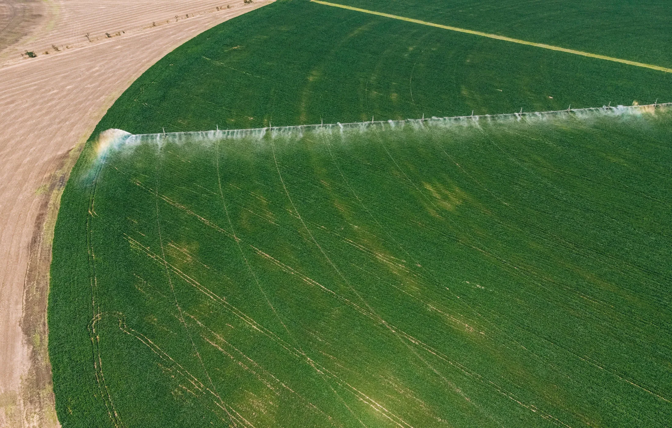 Aerial view of a centre-pivot irrigating a green field